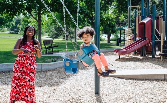 Mother and Toddler Playing on Swings